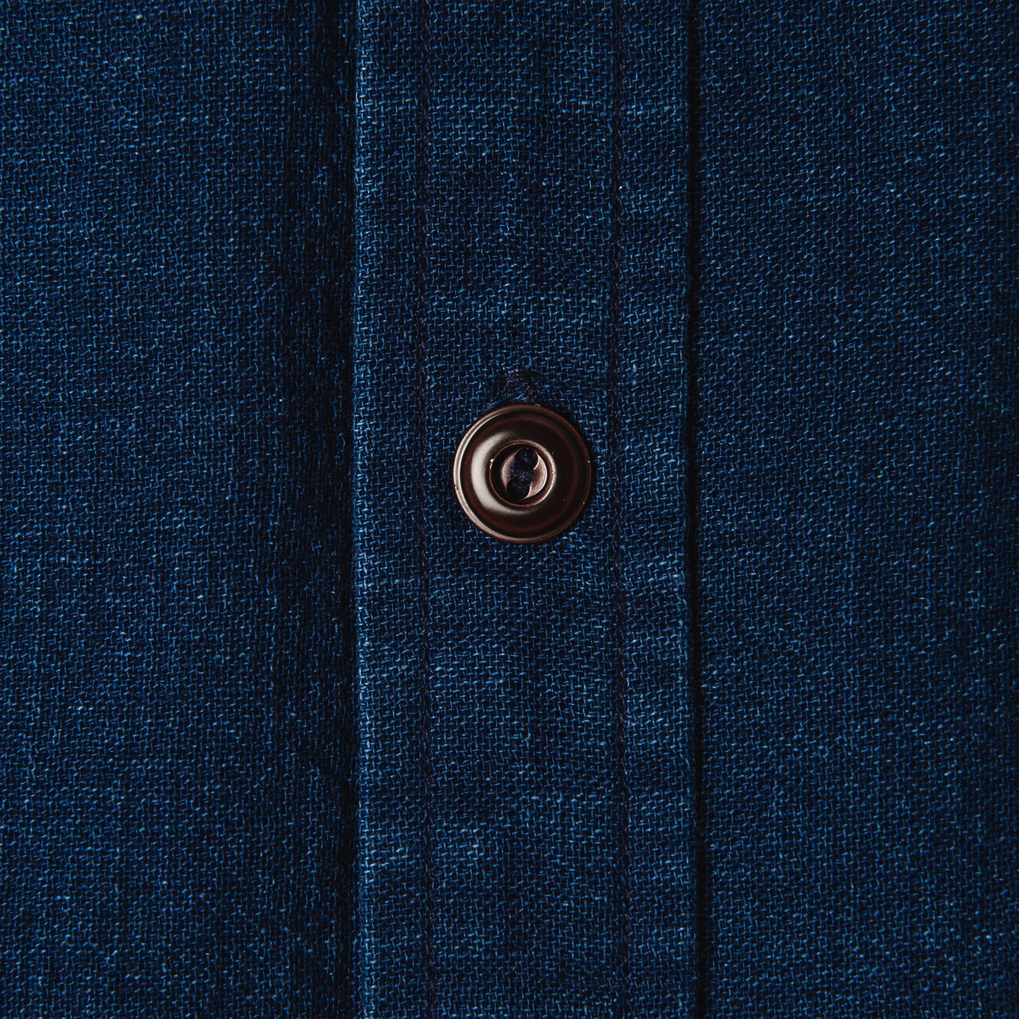 material shot of The Corso Shirt in Indigo Double Cloth close up of the horn button of the placket, Wovens by Taylor Stitch