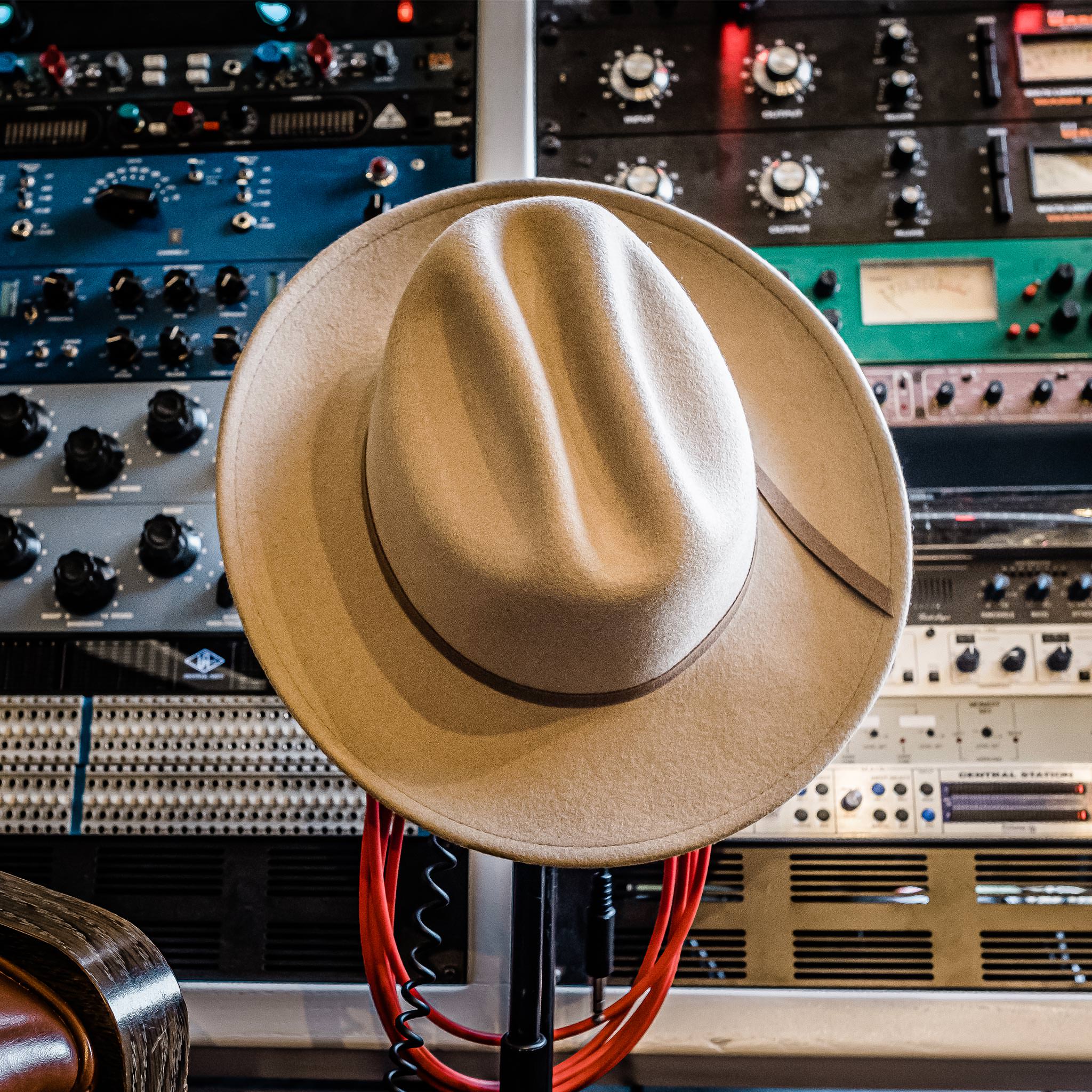 material shot of The Packable Lane Splitter in Mushroom, resting on recording equipment, Accessories by Taylor Stitch