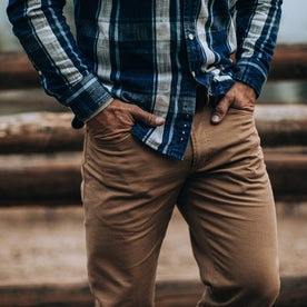 fit model wearing The Democratic All Day Pant in Rustic Oak Organic Selvage, hands in pockets